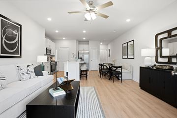 Pooler townhouse for rent - A modern living room with a white couch and a black coffee table.