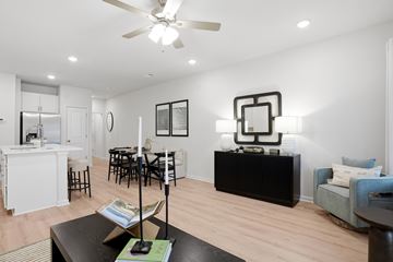Lawrenceville townhouse for rent - A living room with a black coffee table and a white ceiling fan.