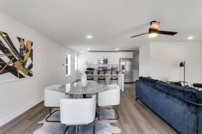 Sugar Hill townhouse for rent - a living room with a blue couch and a dining table
