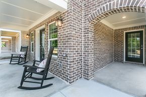 Sugar Hill townhouse for rent - the front porch of a brick house with rocking chairs