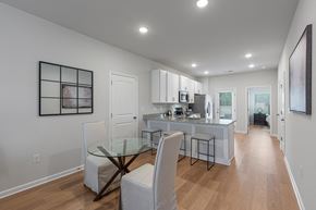 1280 Dunbar Rd apartment for rent - A modern kitchen with a glass table and white chairs.