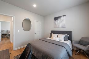 1280 Dunbar Rd apartment for rent - A bedroom with a large bed and a chair.