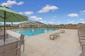 Warner Robins apartment for rent - A pool area with a green umbrella and lounge chairs.