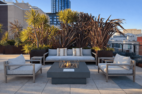 San Francisco apartment for rent - A patio with a fire pit surrounded by chairs and cushions.