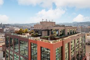 San Francisco apartment for rent - A modern building with a lot of windows and plants on the roof.