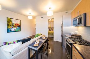 San Francisco apartment for rent - A kitchen with a stove top oven and a microwave above it.