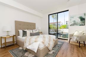 Los Angeles apartment for rent - A bedroom with a large bed and a chair.