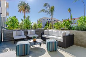 Los Angeles apartment for rent - A patio with a white couch, two chairs, and a coffee table.