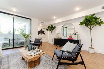Los Angeles apartment for rent - A living room with a black chair and a wooden coffee table.