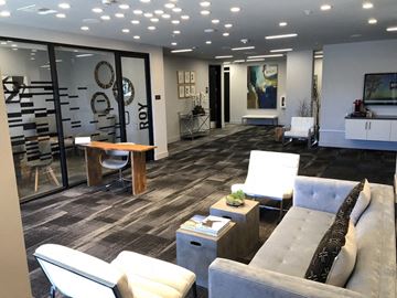 Los Angeles apartment for rent - A modern living room with a grey couch and a wooden coffee table.