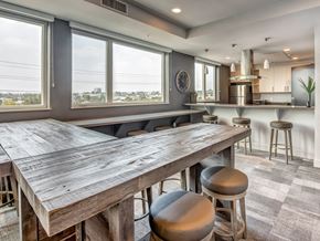 Los Angeles apartment for rent - A kitchen with a large wooden table and bar stools.