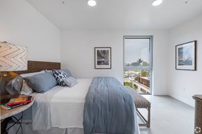Venice apartment for rent - A bedroom with a large bed and a view of the outside.