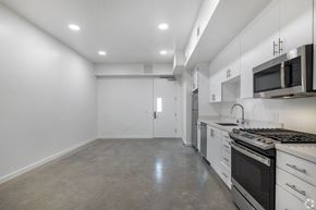 Venice apartment for rent - A kitchen with white cabinets and stainless steel appliances.
