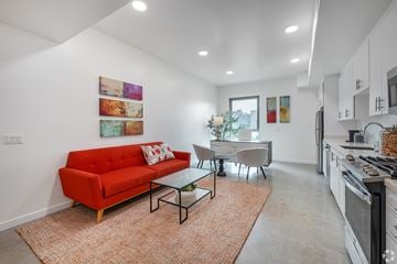 Venice apartment for rent - A red couch sits in a living room with a glass table and chairs.