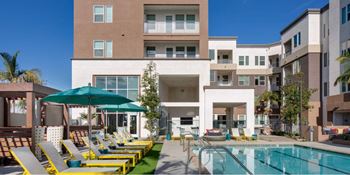 Deluxe pool area featuring pool/spa, cabanas, sun bathing area & indoor/outdoor seating