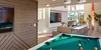Double-height clubhouse w/media wall & game area