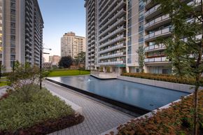 Toronto apartment for rent - a large swimming pool in front of an apartment building