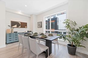 Vancouver apartment for rent - a dining room with a table and chairs and a large window