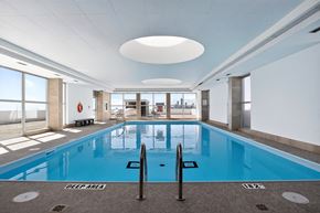 Toronto apartment for rent - A large indoor swimming pool with a deep area marked on the floor.