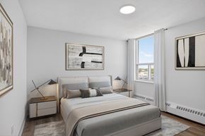 Toronto apartment for rent - A bedroom with a large bed and a window.