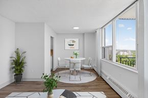 Toronto apartment for rent - A dining room with a table set for two and a view of the city.