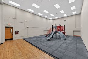 Sioux City apartment for rent - A gym with a slide and a wooden floor.