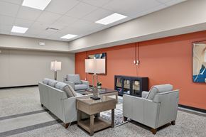 Sioux City apartment for rent - A living room with a grey couch, a coffee table, and a lamp.