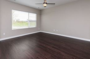 Des Moines apartment for rent - an empty living room with wood floors and a window at 5Fifty5, Iowa  