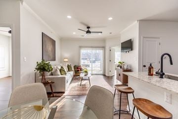 West Des Moines apartment for rent - A modern living room with a glass table and chairs.