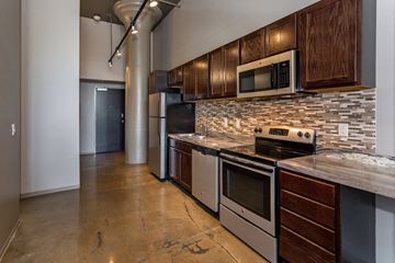 Des Moines apartment for rent - A kitchen with a stove top oven and microwave.