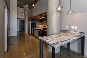 Des Moines apartment for rent - Kitchen with a marble counter top and a stainless steel at Ballyard Lofts, Indigo Living, IA, 50309