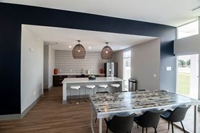 Waukee apartment for rent - a dining room and kitchen with a marble table and chairs at Centennial Crossing, Iowa, 50263