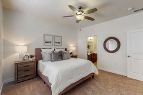 Waukee apartment for rent - a bedroom with a bed and a ceiling fan at Centennial Crossing, Iowa, 50263