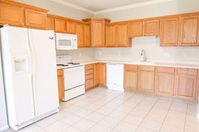 West Des Moines apartment for rent - a kitchen with white appliances and wooden cabinets at Diamond Brooke, West Des Moines Iowa  