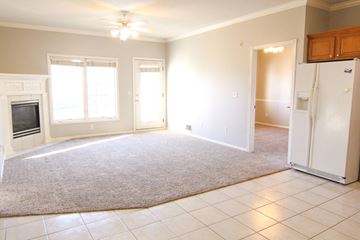 West Des Moines apartment for rent - A white kitchen with a refrigerator and a fireplace.