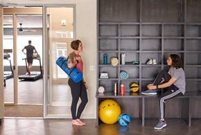 Des Moines apartment for rent - two women working out in a gym with weights and a yoga ball at Velocity Apartments, IA, 50309