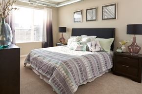 Des Moines apartment for rent - a bedroom with a bed and a dresser and a window at Velocity Apartments, Iowa