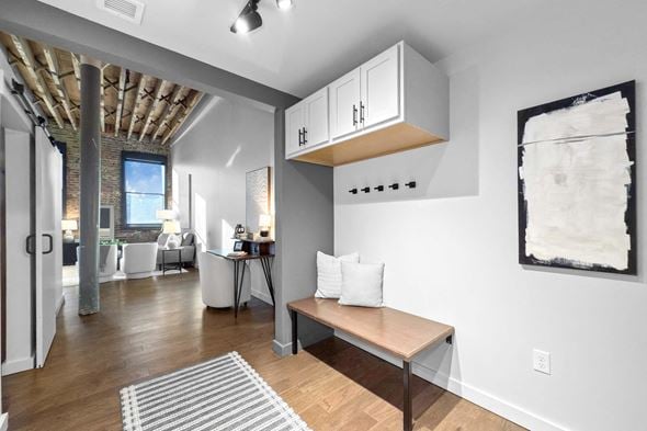 Newton apartment for rent - A room with a bench and a painting on the wall.at Plant 1 Lofts, Iowa, 50208