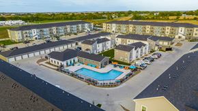 Pleasant Hill apartment for rent - an aerial view of an apartment complex with a swimming pool at Forge65, Pleasant Hill, 50327