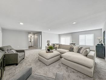 A large living room with a couch and a chair