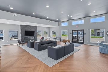 Norwalk townhouse for rent - A spacious living room with a grey sofa set and a television.