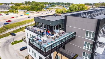 A group of people are sitting on a balcony of a building.
