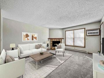 Sioux Falls apartment for rent - A living room with a fireplace and a painting on the wall.