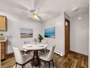 Sioux Falls apartment for rent - a dining room with a table and chairs and a ceiling fan at Creekstone Falls, Sioux Falls
