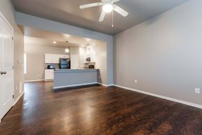 Carlisle apartment for rent - A spacious kitchen with a ceiling fan and wooden floors. at Danamere Village, Iowa, 50047