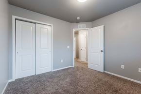 Carlisle apartment for rent - A room with white doors and carpeted floor. at Danamere Village, Carlisle, 50047
