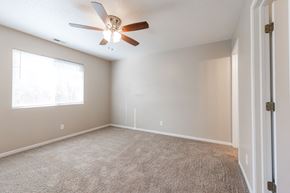 Polk City apartment for rent - A room with a ceiling fan and a carpeted floor. at Saylorville Lakeside, Polk City, 50226