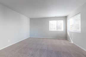 Polk City apartment for rent - A spacious room with carpeted floor and two windows. at Saylorville Lakeside, Polk City, Iowa