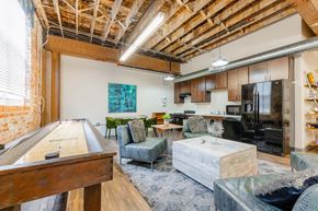 Grinnell apartment for rent - A room with a pool table and a couch at Spaulding Lofts Apartments, Grinnell