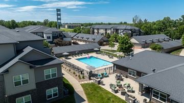 Clive apartment for rent - A large building complex with a pool in the middle.